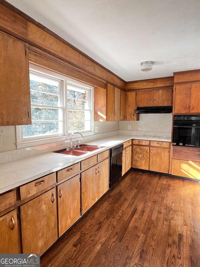 kitchen with backsplash, dark wood-type flooring, sink, and black appliances