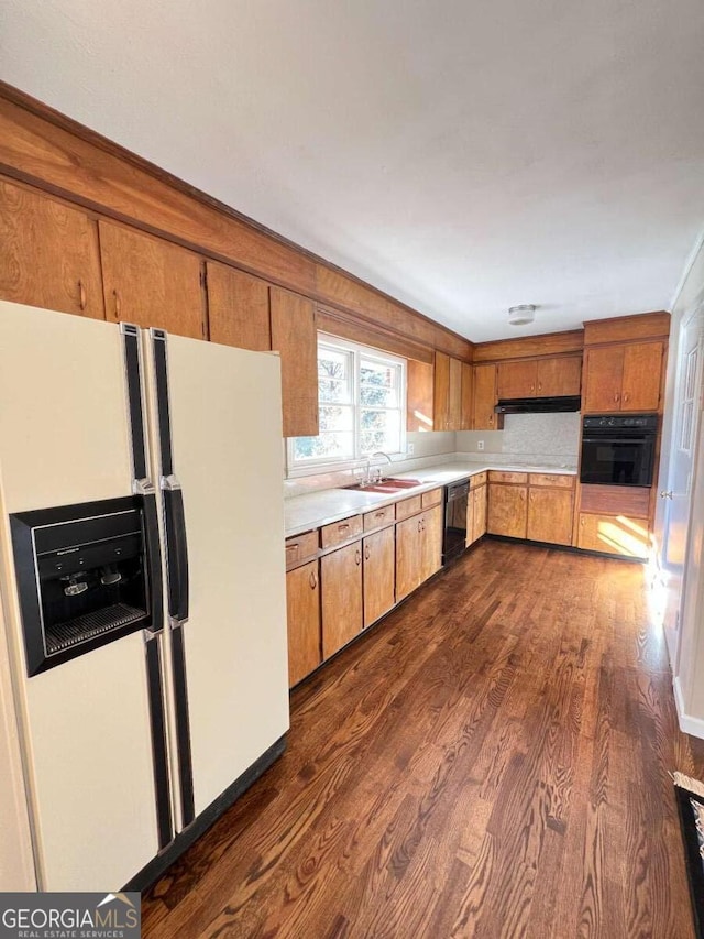 kitchen featuring sink, dark hardwood / wood-style flooring, and black appliances