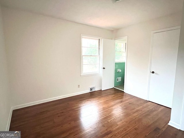 unfurnished bedroom featuring dark hardwood / wood-style floors