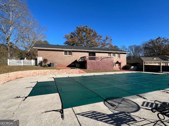 view of swimming pool with central AC, a patio area, and a wooden deck