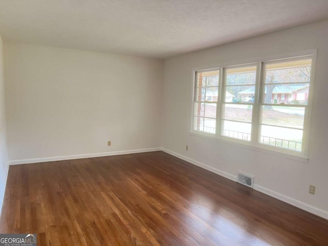 empty room featuring dark hardwood / wood-style floors