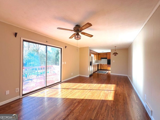 unfurnished living room featuring a textured ceiling, crown molding, ceiling fan, and dark hardwood / wood-style floors