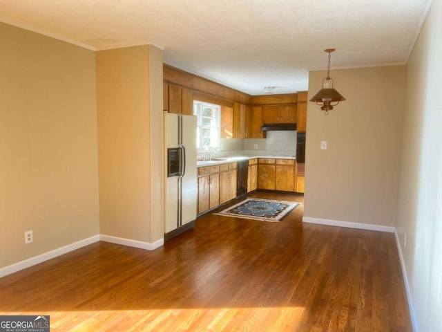 kitchen with pendant lighting, dishwasher, white refrigerator with ice dispenser, dark wood-type flooring, and sink