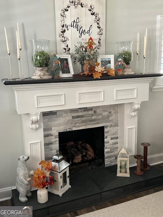 interior details featuring a fireplace and hardwood / wood-style floors