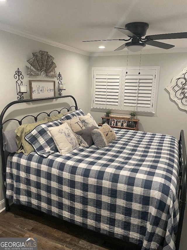 bedroom with crown molding, ceiling fan, and dark hardwood / wood-style floors