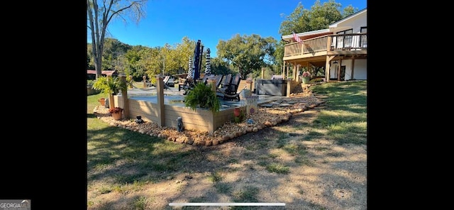 view of yard with a wooden deck and a patio area