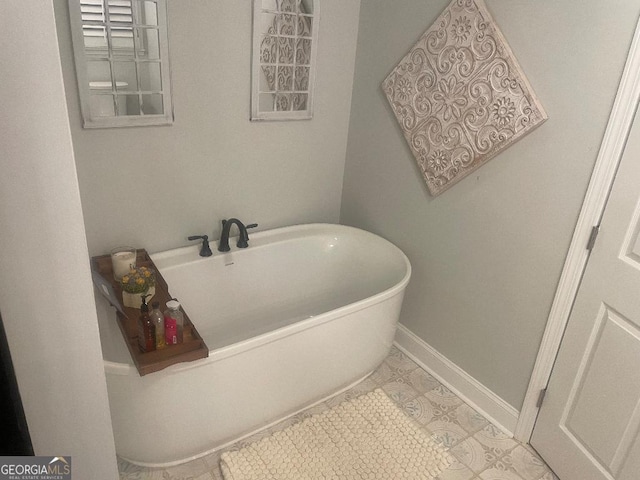 bathroom featuring a tub to relax in and tile patterned flooring