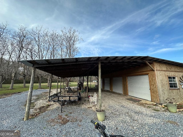 view of vehicle parking with a garage and a carport