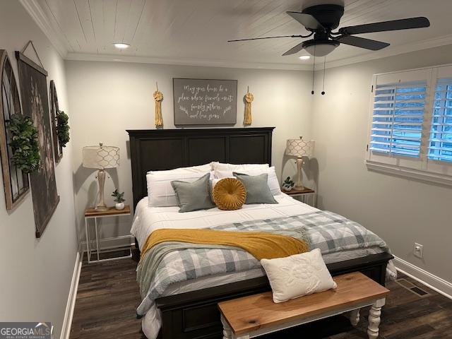 bedroom with dark hardwood / wood-style flooring, ornamental molding, and ceiling fan