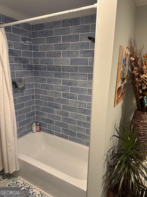 bathroom with tile patterned flooring, ornamental molding, and shower / bath combination with curtain