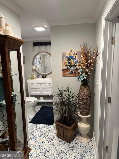 bathroom with vanity, tile patterned floors, ornamental molding, and toilet