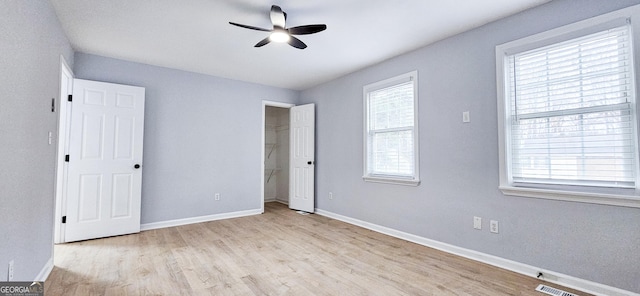 unfurnished bedroom featuring ceiling fan, a closet, and light hardwood / wood-style flooring