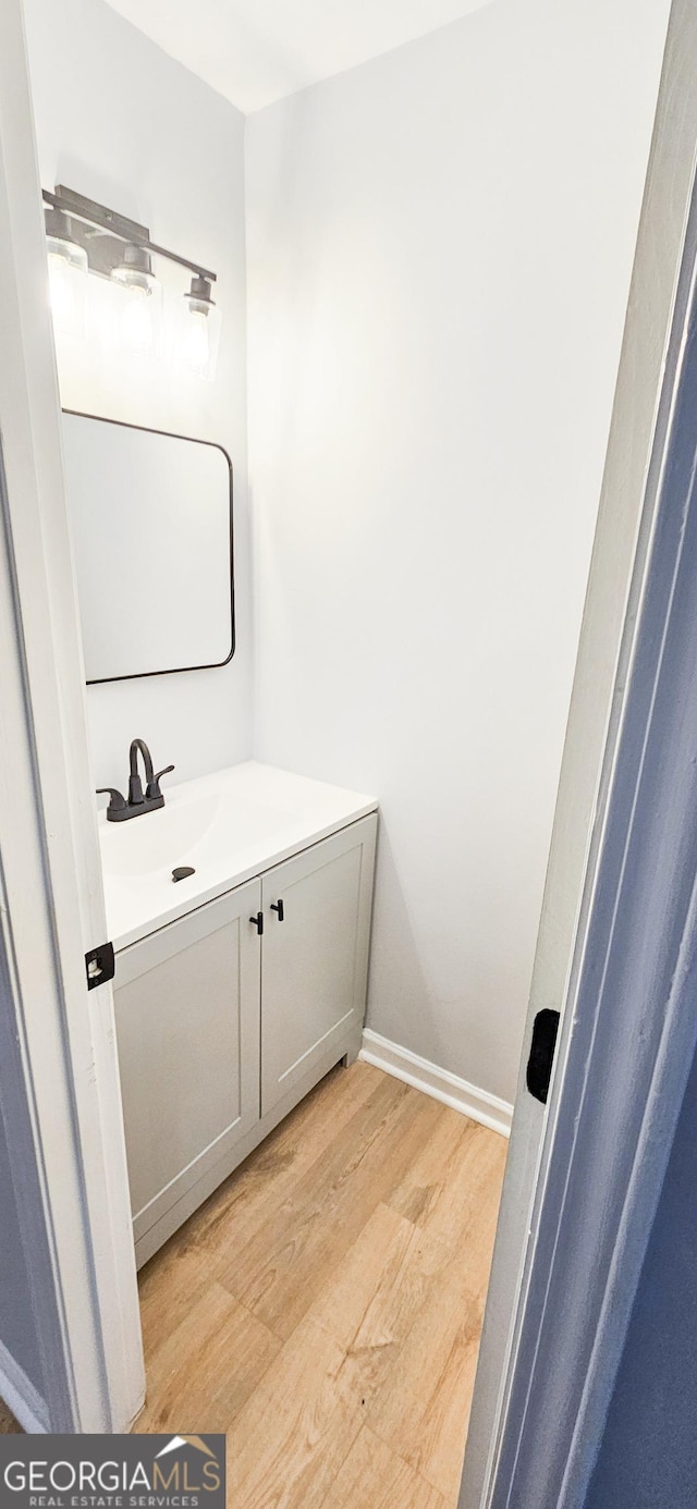 bathroom featuring vanity and wood-type flooring