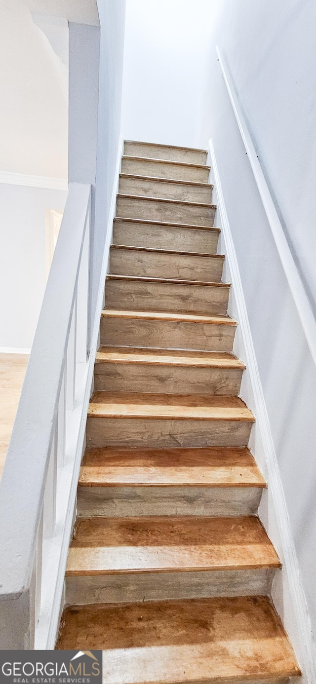 stairway with hardwood / wood-style floors