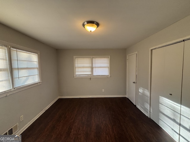 unfurnished bedroom featuring dark wood-type flooring