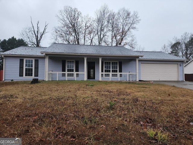 ranch-style house featuring a front lawn, a porch, and a garage