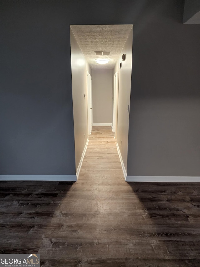 hallway featuring hardwood / wood-style flooring