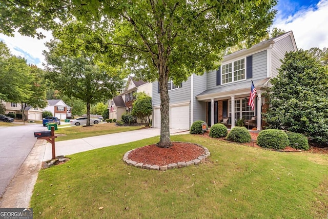 view of property featuring a garage and a front lawn