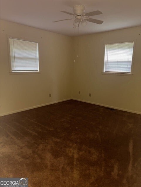 carpeted empty room with ceiling fan