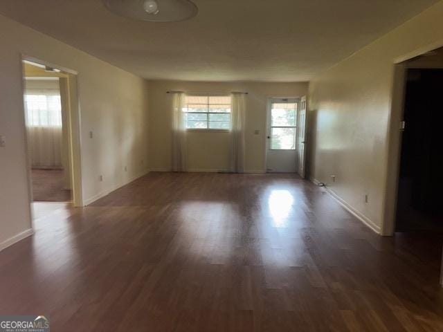 unfurnished room featuring dark hardwood / wood-style flooring