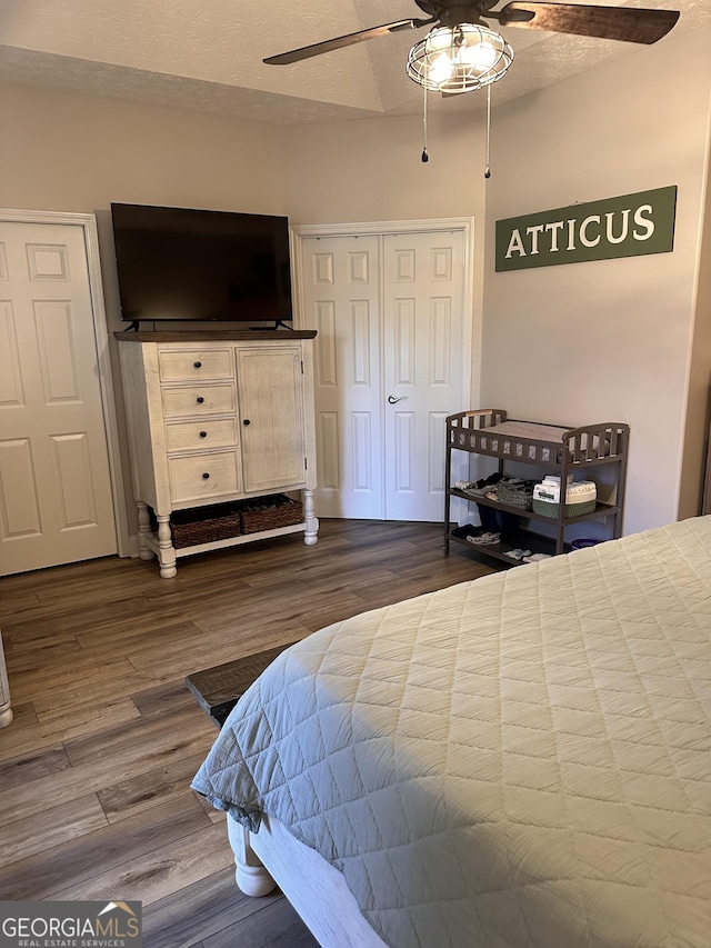 bedroom featuring ceiling fan, wood-type flooring, and a textured ceiling