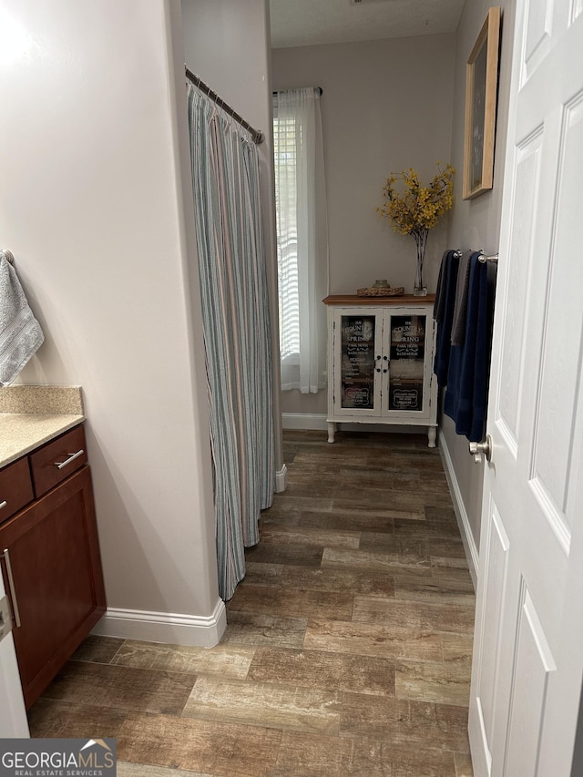 bathroom with vanity and wood-type flooring