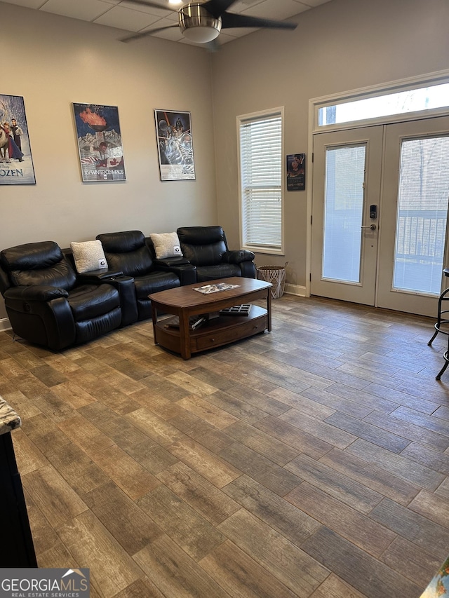 living room featuring ceiling fan, a healthy amount of sunlight, and wood-type flooring