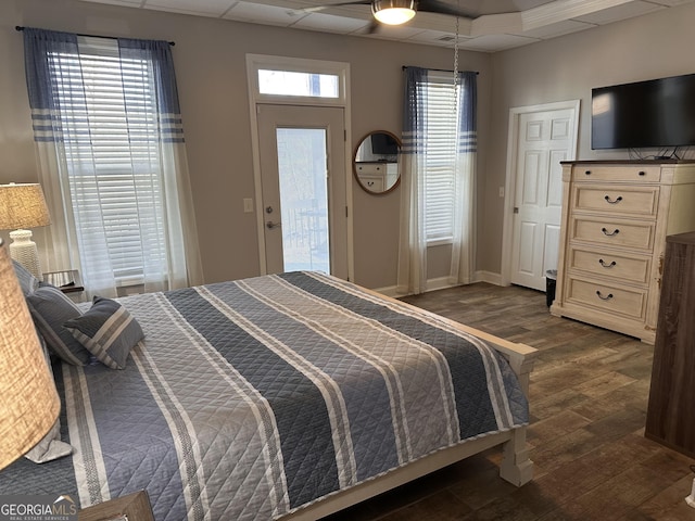 bedroom with access to exterior, ceiling fan, and dark hardwood / wood-style flooring