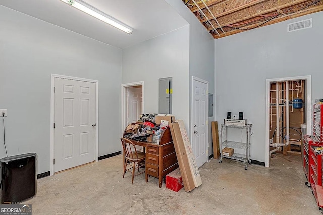 interior space with electric panel and a high ceiling