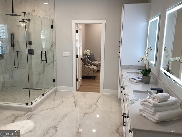 bathroom featuring vanity and a shower with shower door