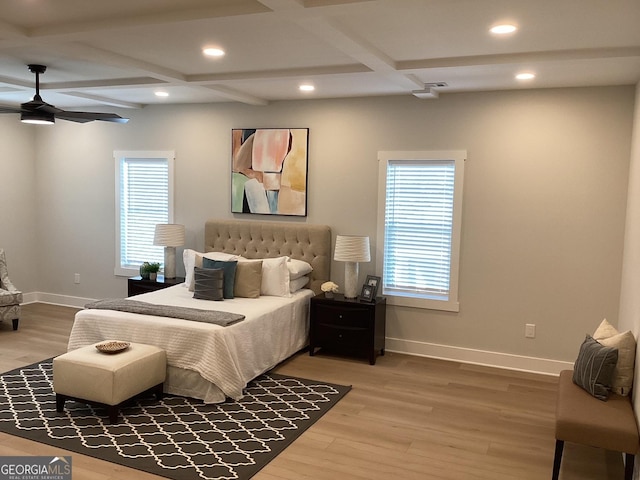 bedroom featuring hardwood / wood-style flooring, coffered ceiling, and multiple windows