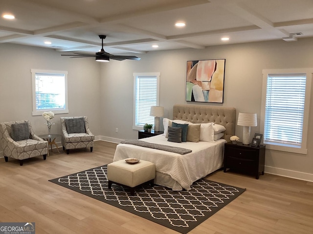 bedroom featuring hardwood / wood-style flooring, coffered ceiling, and multiple windows