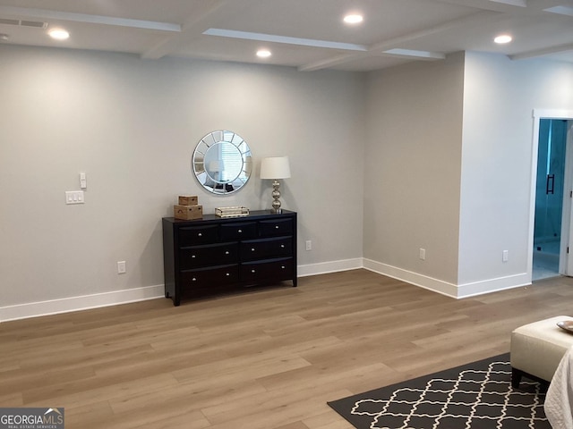 living area with hardwood / wood-style flooring, coffered ceiling, and beam ceiling