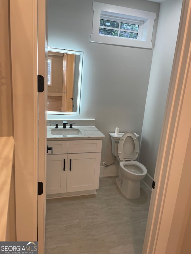 bathroom featuring vanity and toilet