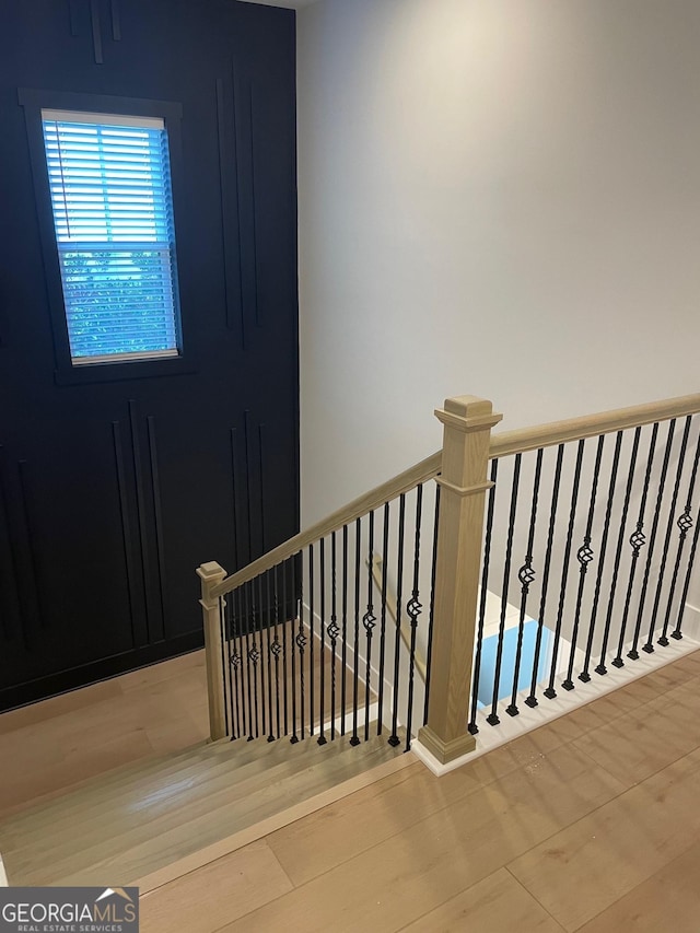 staircase featuring wood-type flooring