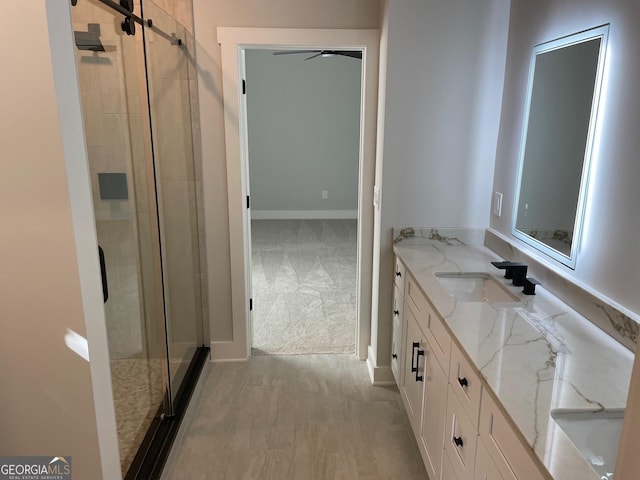 bathroom featuring vanity, hardwood / wood-style floors, and a shower with door