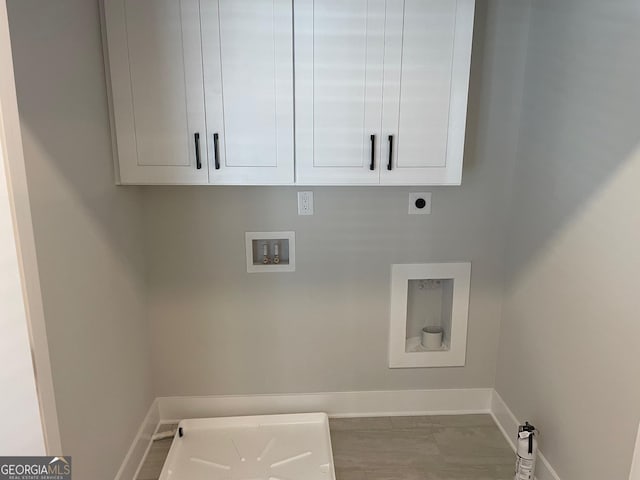 clothes washing area with cabinets, hookup for a washing machine, and hookup for an electric dryer