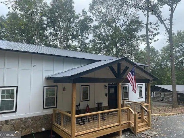 rear view of house featuring covered porch