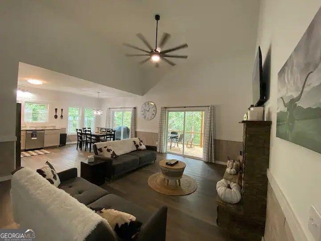 living room with hardwood / wood-style flooring, ceiling fan, and high vaulted ceiling