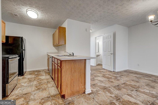 kitchen featuring sink, kitchen peninsula, a chandelier, a textured ceiling, and appliances with stainless steel finishes