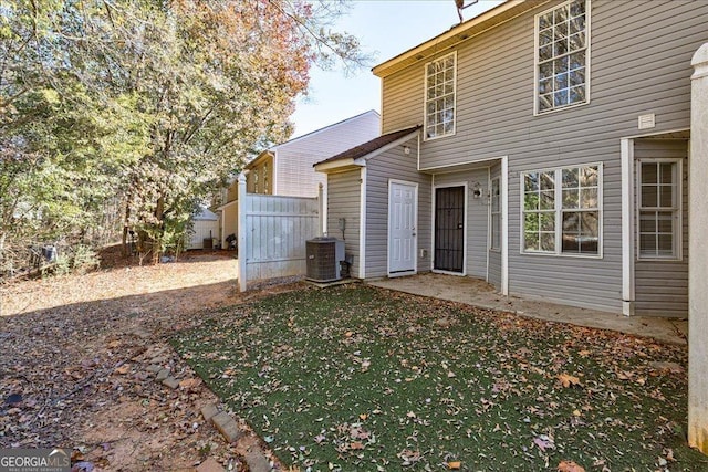 rear view of house featuring central AC