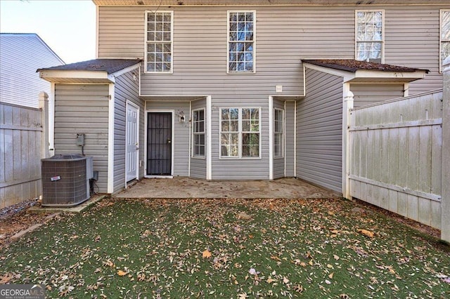 rear view of house featuring cooling unit and a patio