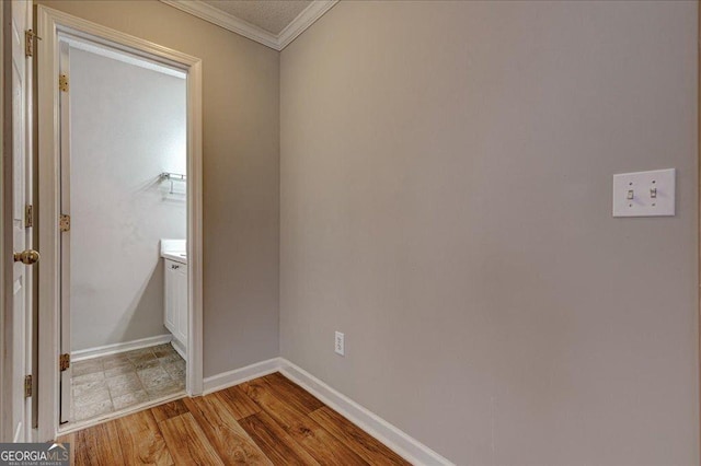 interior space featuring crown molding and light hardwood / wood-style flooring