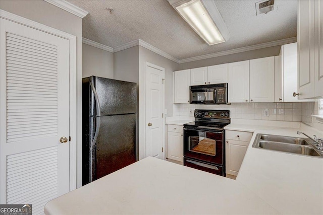 kitchen featuring black appliances, crown molding, white cabinetry, and sink