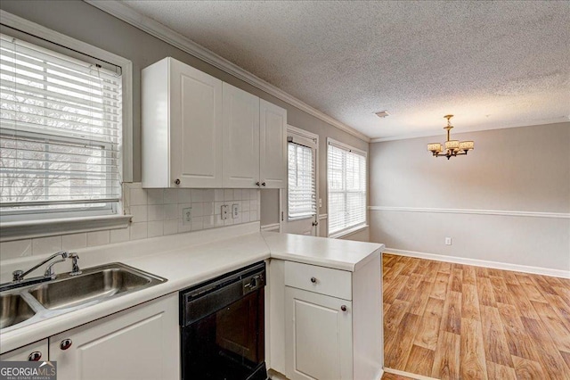 kitchen featuring white cabinetry, dishwasher, plenty of natural light, and sink