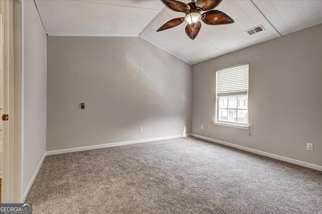 carpeted empty room with ceiling fan and lofted ceiling