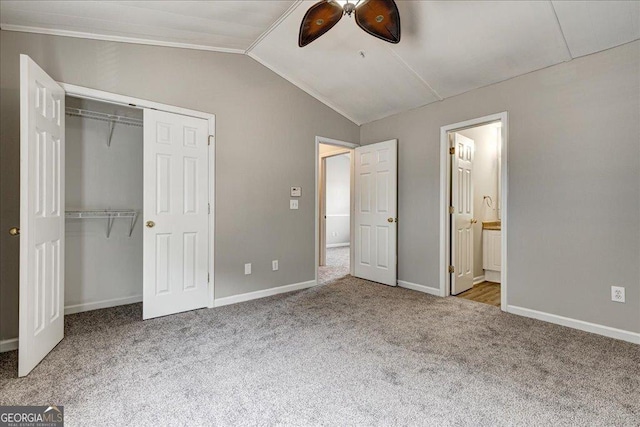 unfurnished bedroom with carpet flooring, ensuite bath, ceiling fan, and lofted ceiling