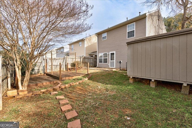 rear view of property featuring a lawn