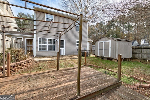 deck with central AC unit and a storage unit