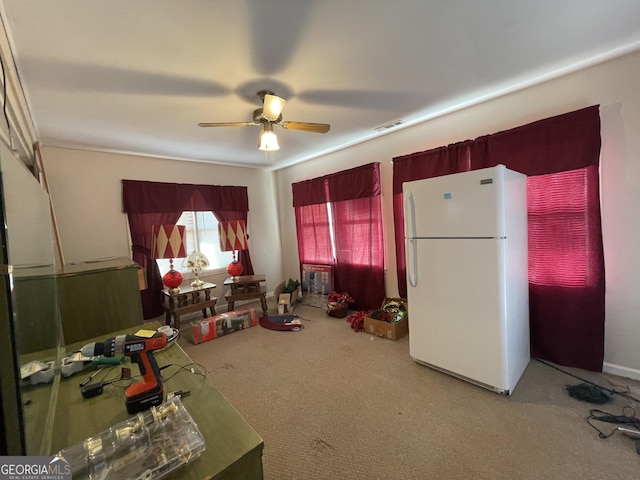 interior space with ceiling fan and carpet floors